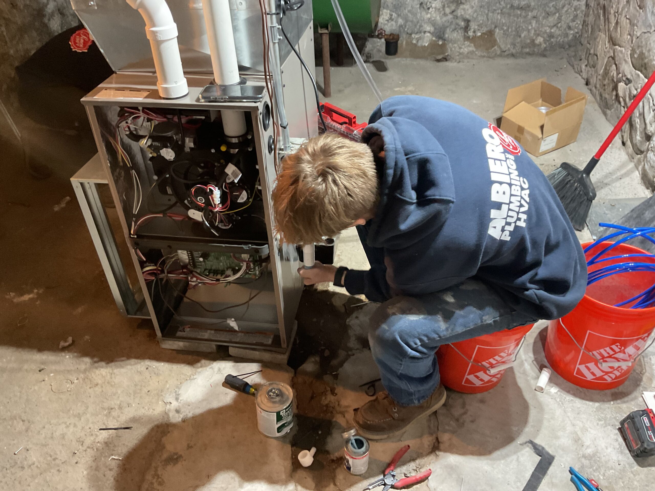 Albiero tech diagnosing furnace in basement