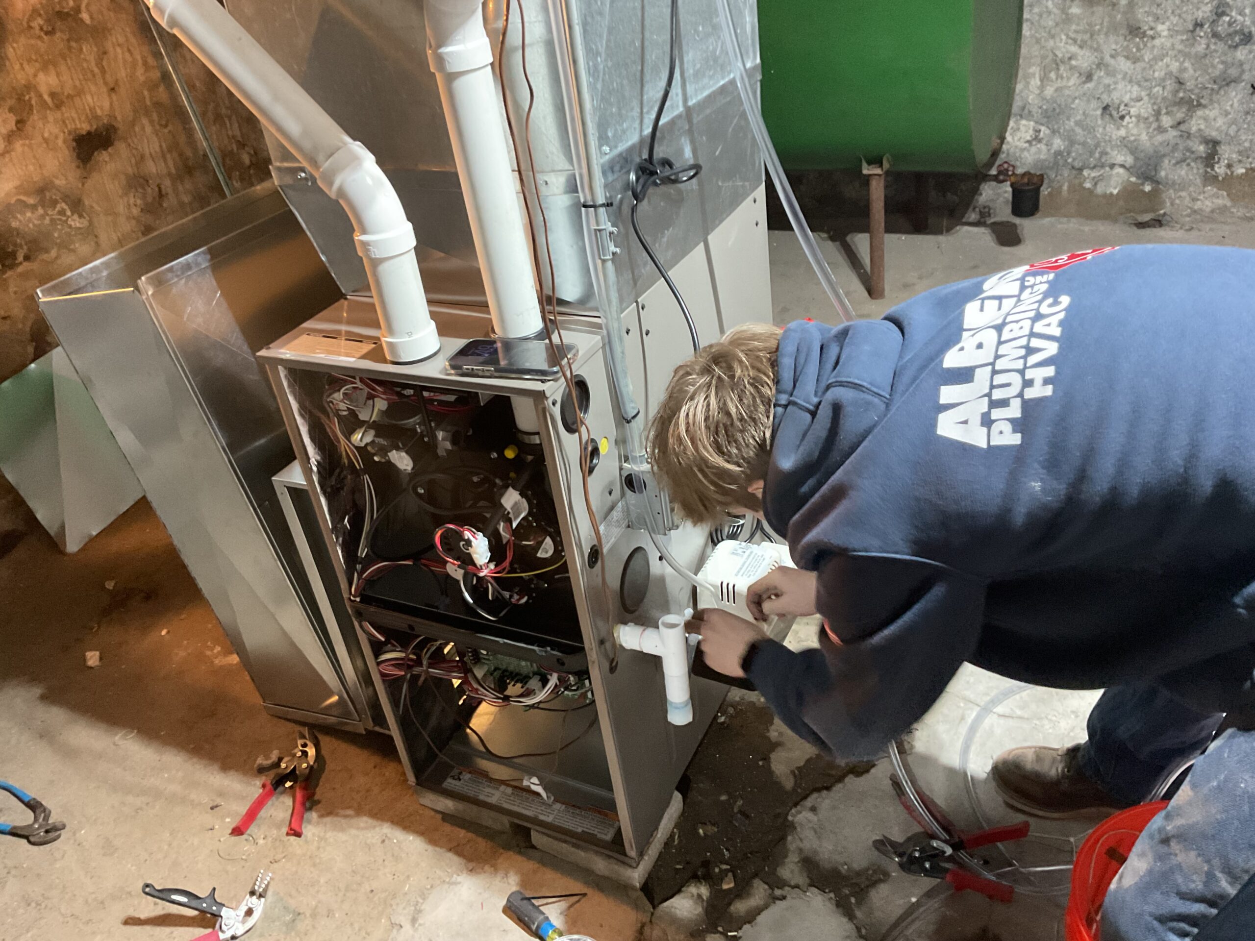 Albiero tech working on furnace with PVC venting