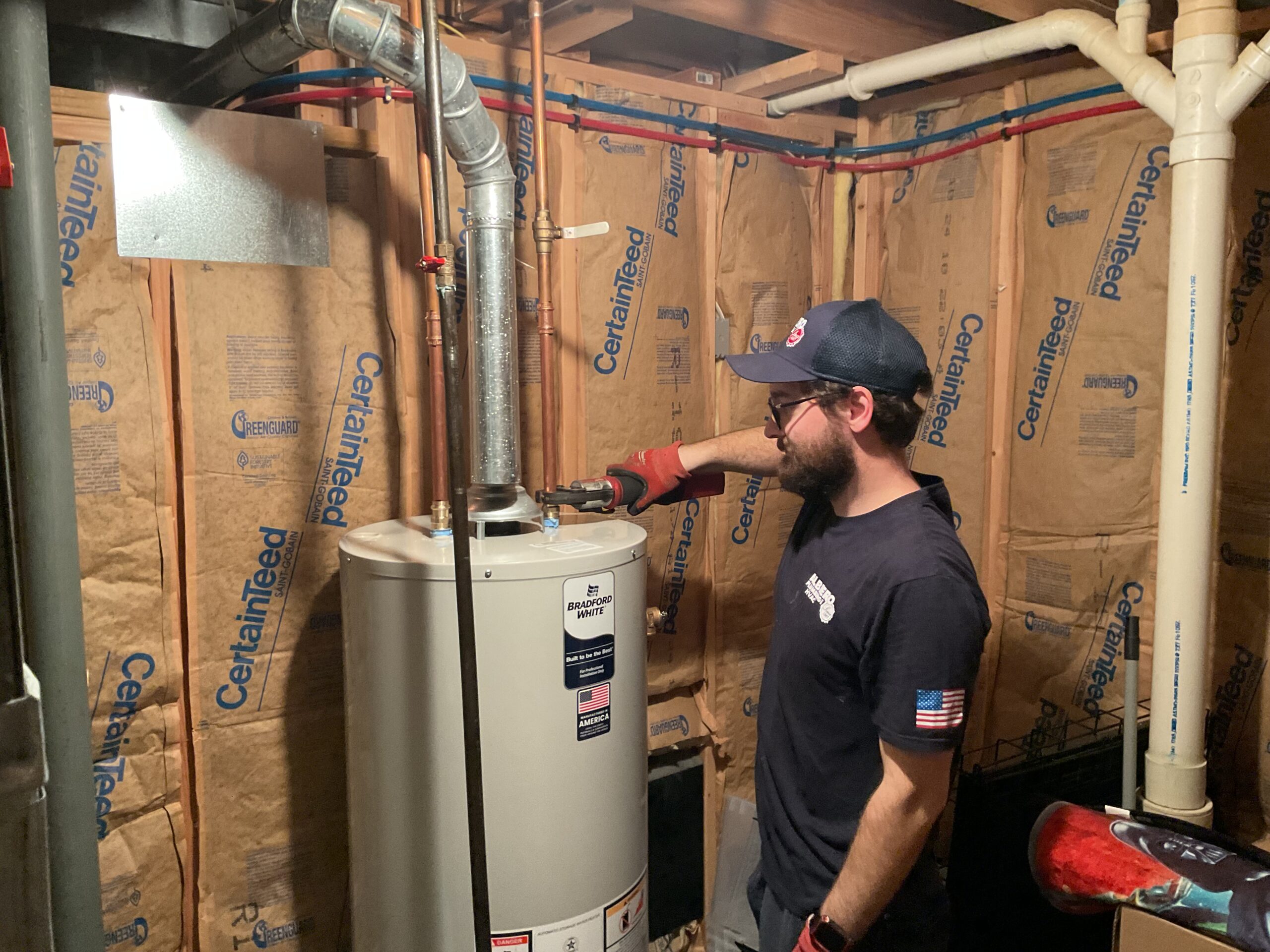 Albiero tech inspecting water heater connections